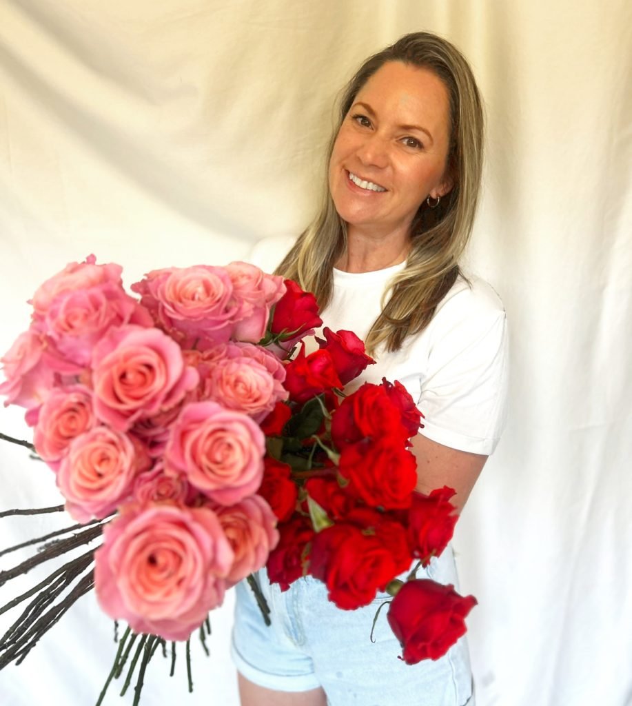 Wedding Florist holding red and pink roses
