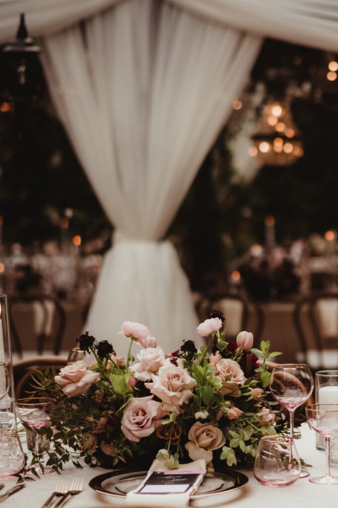 Dusk at an elegant wedding reception outdoors in the garden
